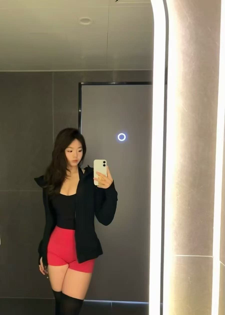 教练在镜前记录运动穿搭与状态